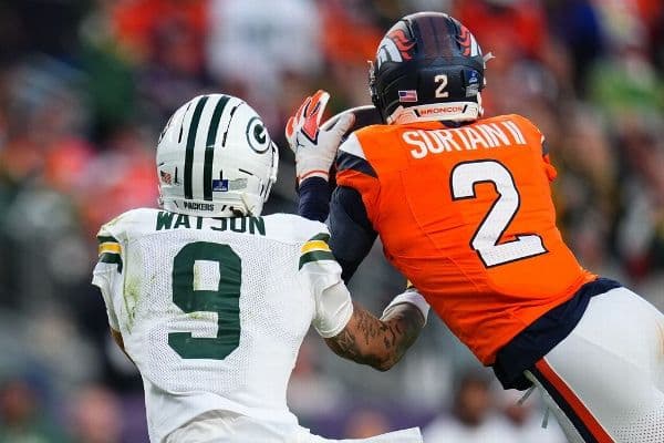 Pat Surtain II beats Packers WR Christian Watson to the ball for his first interception of the season.