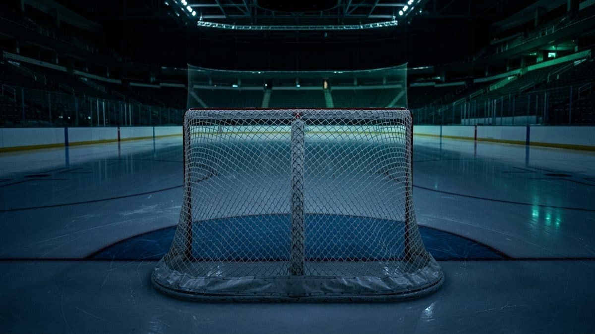 An empty hockey rink under the lights before the opening faceoff