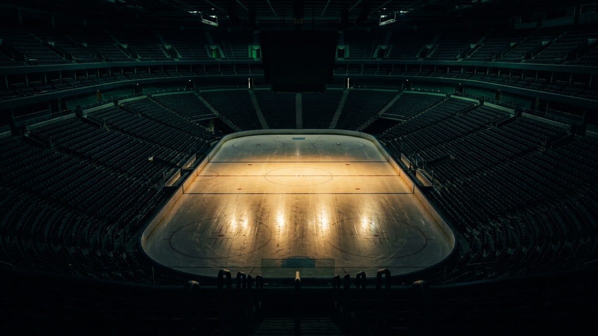 An empty hockey rink under the lights before the opening faceoff