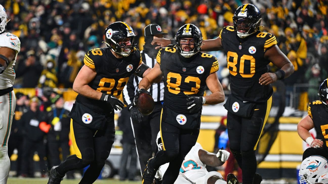 Steelers tight ends Pat Freiermuth (88), Connor Heyward (83) and Darnell Washington (80) celebrate Heyward's touchdown run in the first half against the Dolphins in Pittsburgh.