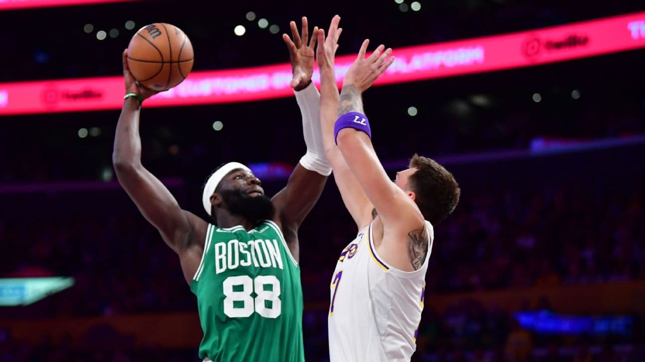 Boston Celtics center Neemias Queta dunks over Los Angeles Lakers guard Luka Doncic.