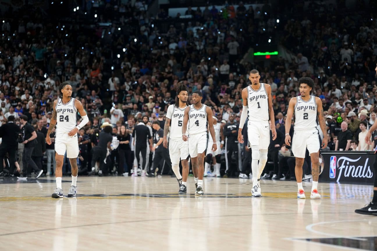 Devin Vassell (24), Stephon Castle (5), De'Aaron Fox (4), Victor Wembanyama (1) and Dylan Harper (2) of the San Antonio Spurs walk back on the court in the fourth quarter during Game 2 of the 2026 NBA