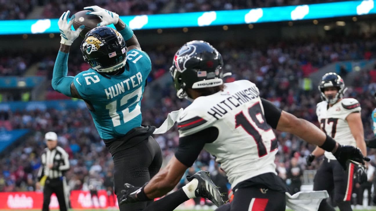 Travis Hunter starred on both sides of the ball Sunday, recording an interception (seen here) -- and a touchdown catch in the Jaguars' 34-31 loss in London.