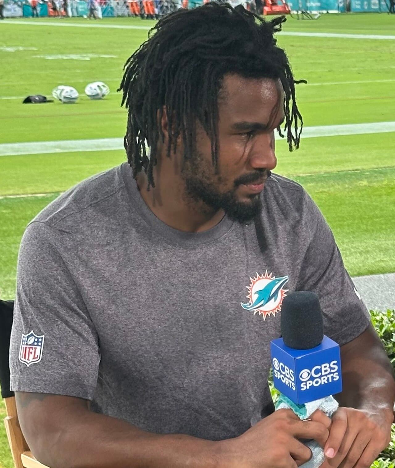 Jaylen Waddle being interviewed by CBS Sports at Miami Dolphins training camp in July 2025